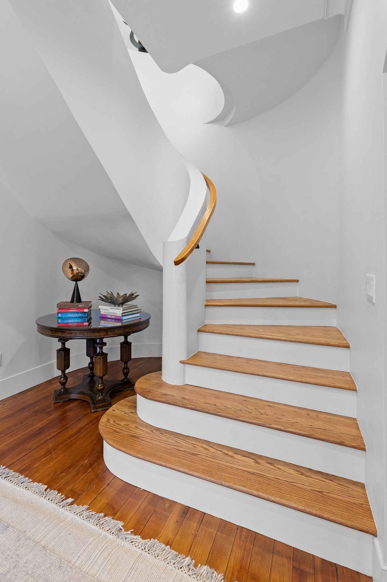 Gaudí-inspired curved staircase with sweeping plaster walls
