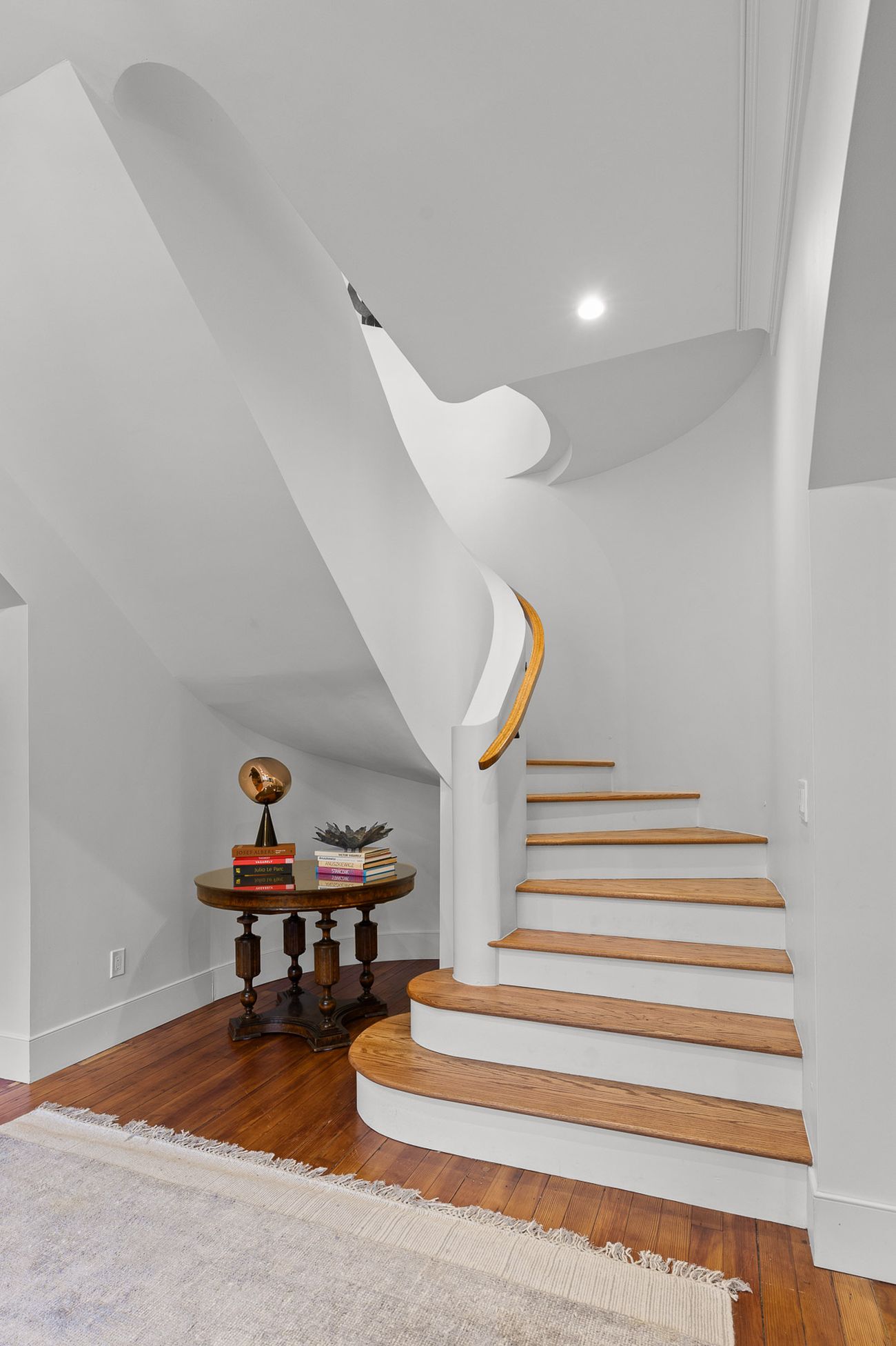 Hand-shaped oak handrail on the curved staircase