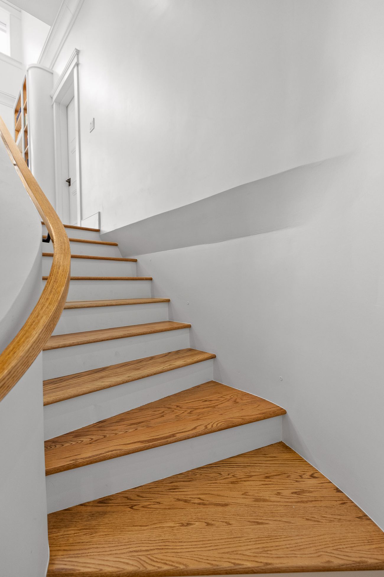 Sculptural staircase rising through the restored home
