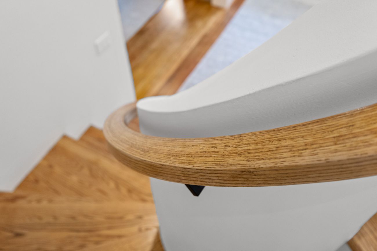Hand-shaped oak handrail on the curved staircase