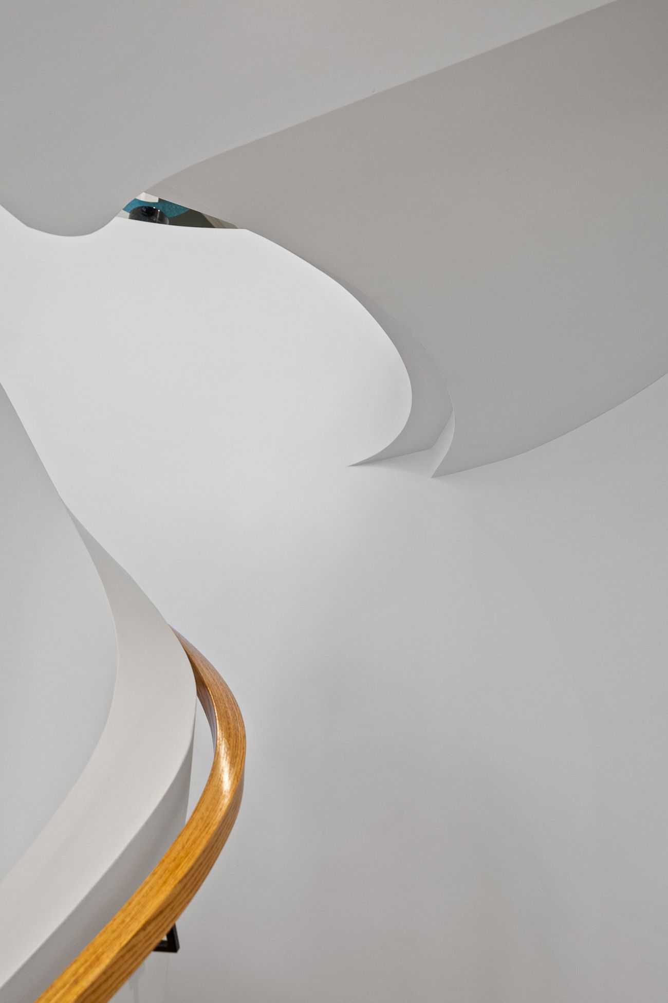 Gaudí-inspired curved staircase with sweeping plaster walls