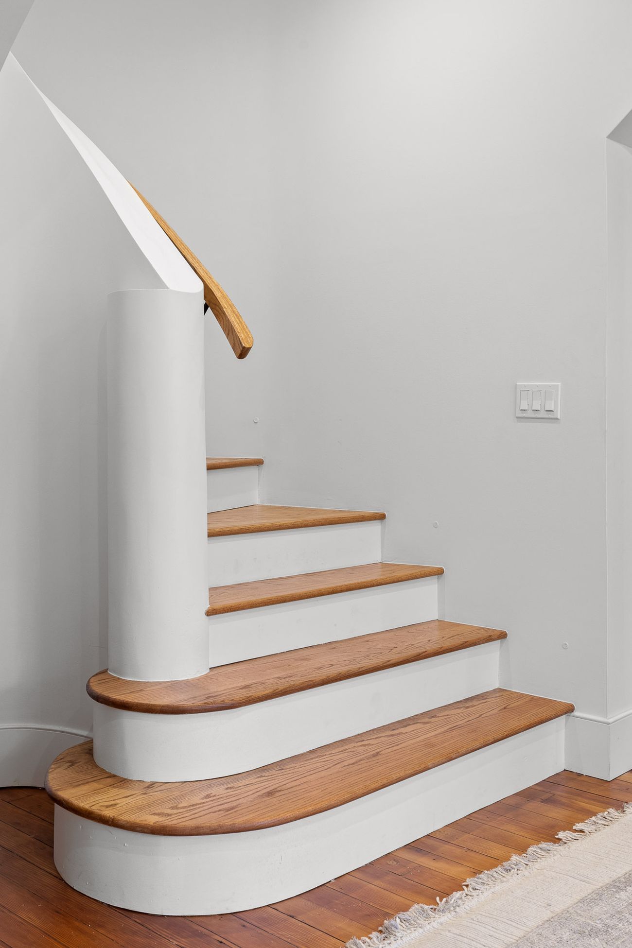 Gaudí-inspired curved staircase with sweeping plaster walls
