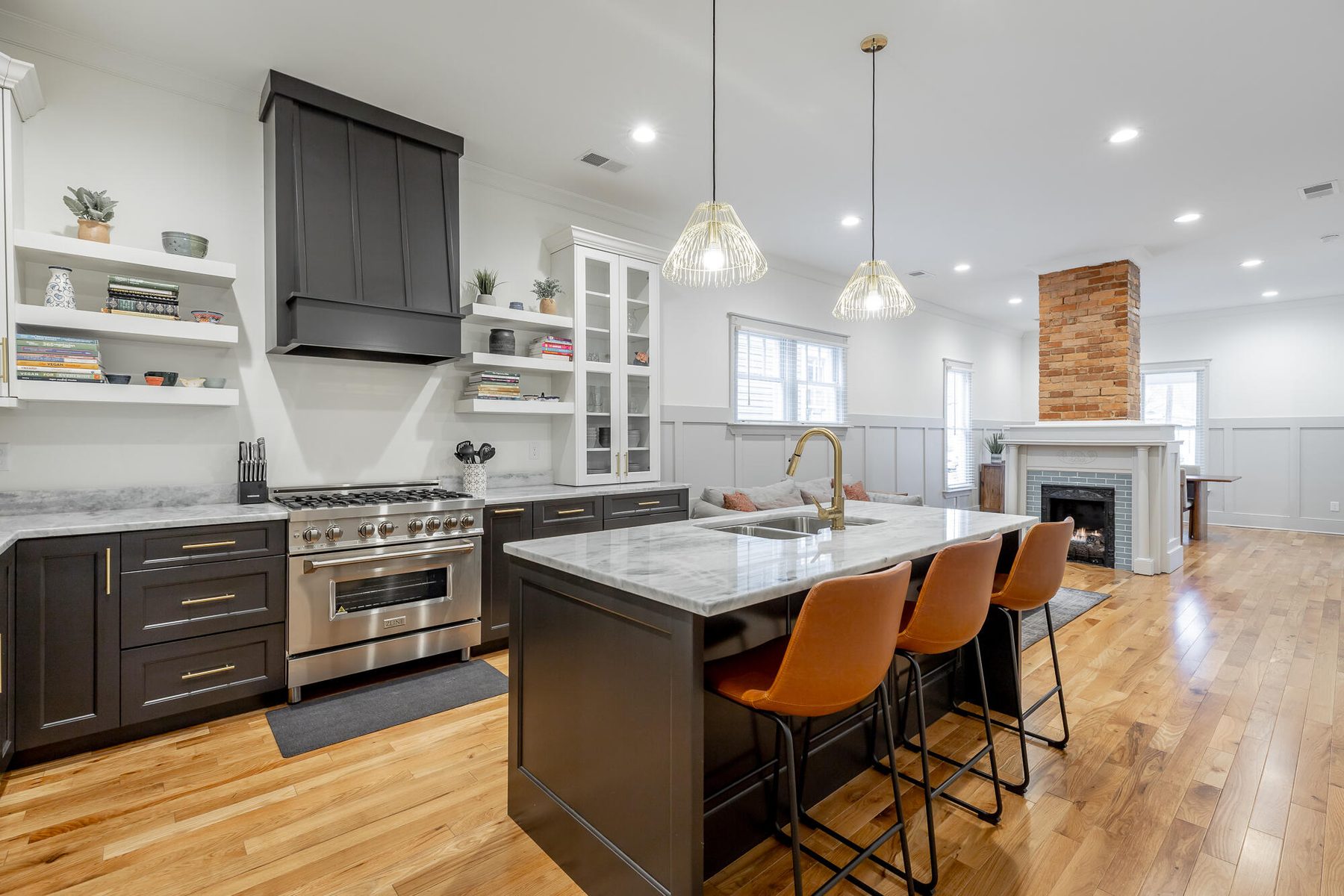 Restored kitchen with a marble island and original brick fireplace in St. Elmo