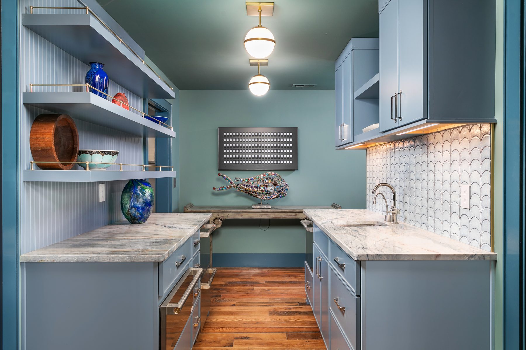 Butler's pantry in soft blue cabinetry with open shelving and a marble counter at 1815 Williams Street